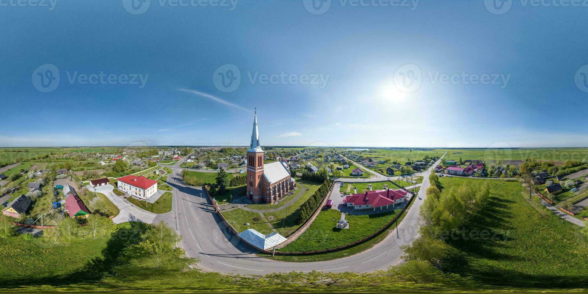 full hdri 360 panorama aerial view on red brick neo gothic catholic church in countryside or village in equirectangular projection with zenith and nadir. VR  AR content photo