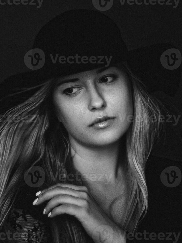 Beautiful blonde woman wearing a hat, artistic film portrait in black and white for fashion campaign and beauty brand photo