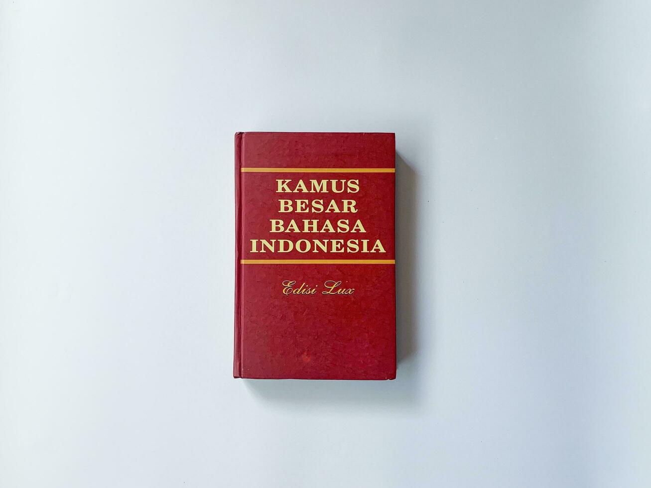 Yogyakarta, Indonesia, 26 Jan 2023 - A standard Indonesian language dictionary with a red cover, captured from a top-down perspective. photo