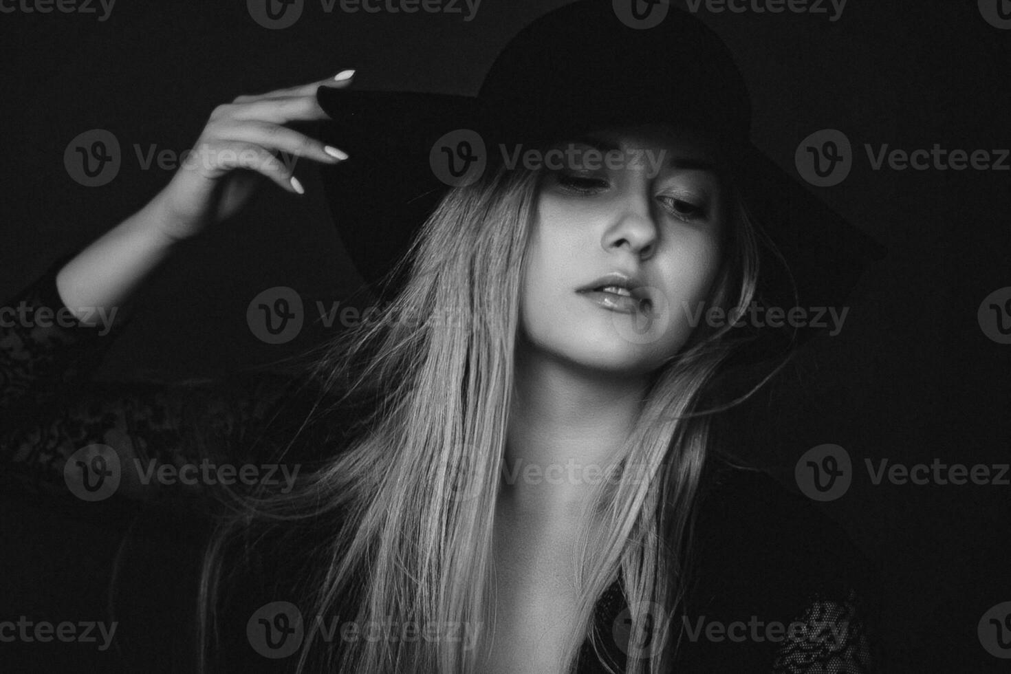 Beautiful blonde woman wearing a hat, artistic film portrait in black and white for fashion campaign and beauty brand photo