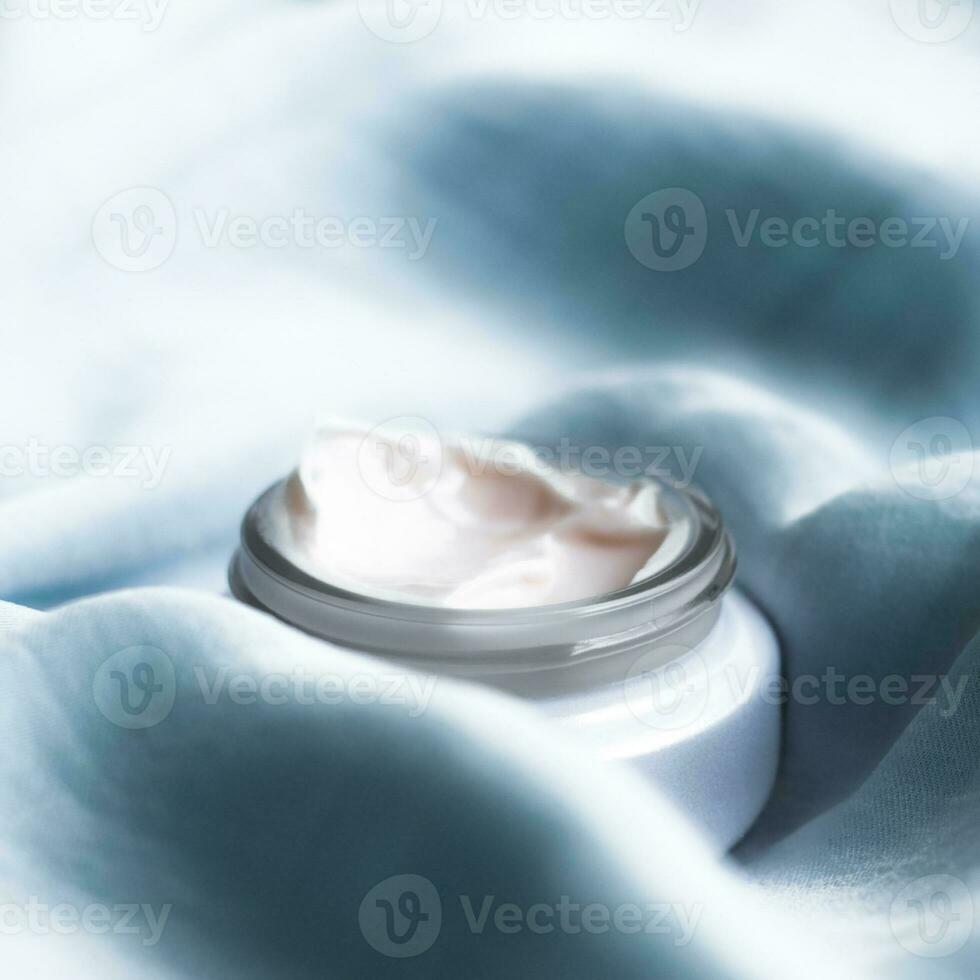 luxury face cream on soft silk - anti-aging, cosmetic and beauty styled concept photo