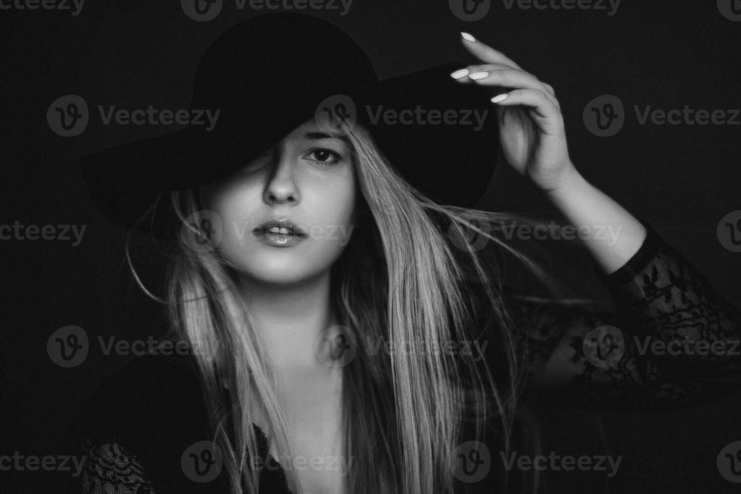 Beautiful blonde woman wearing a hat, artistic film portrait in black and white for fashion campaign and beauty brand photo