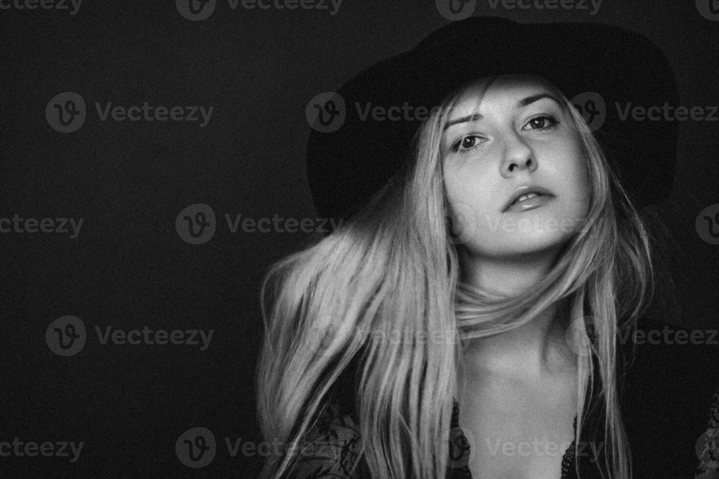 Beautiful blonde woman wearing a hat, artistic film portrait in black and white for fashion campaign and beauty brand photo