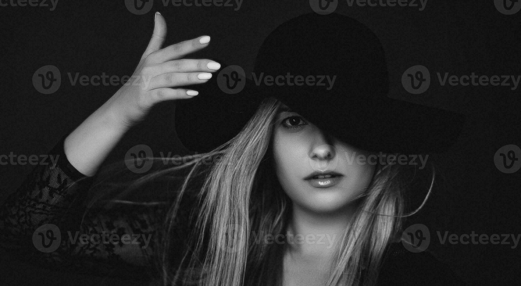 Beautiful blonde woman wearing a hat, artistic film portrait in black and white for fashion campaign and beauty brand photo