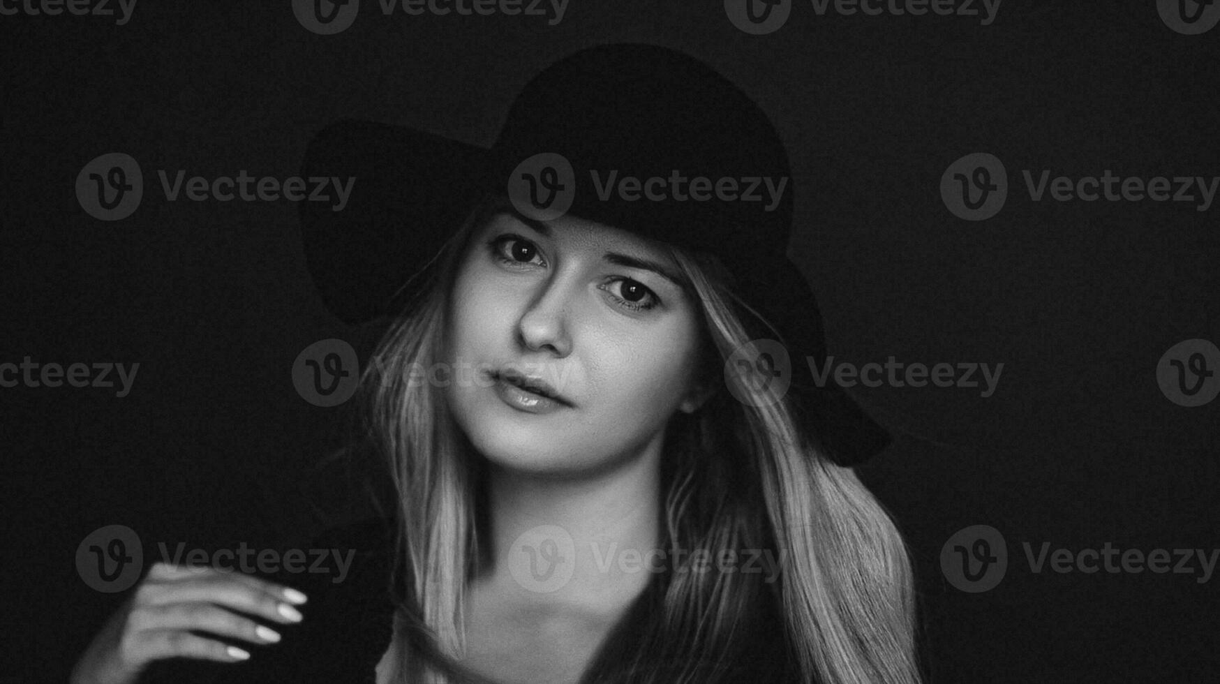 Beautiful blonde woman wearing a hat, artistic film portrait in black and white for fashion campaign and beauty brand photo