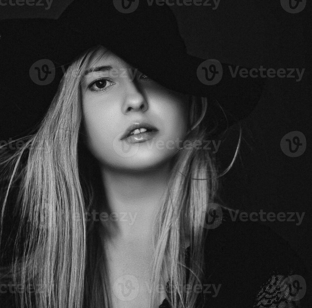 Beautiful blonde woman wearing a hat, artistic film portrait in black and white for fashion campaign and beauty brand photo