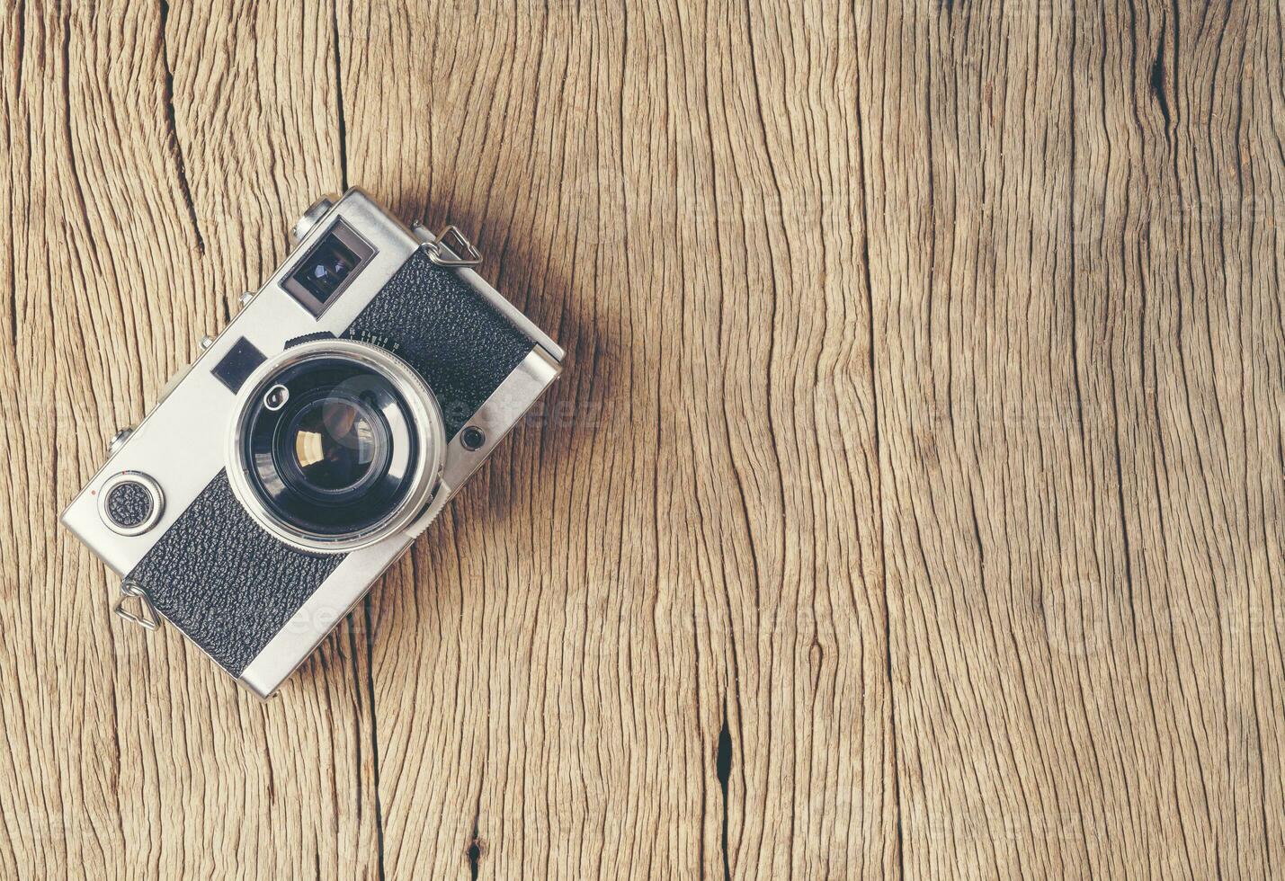 vintage old film camera on wood board photo