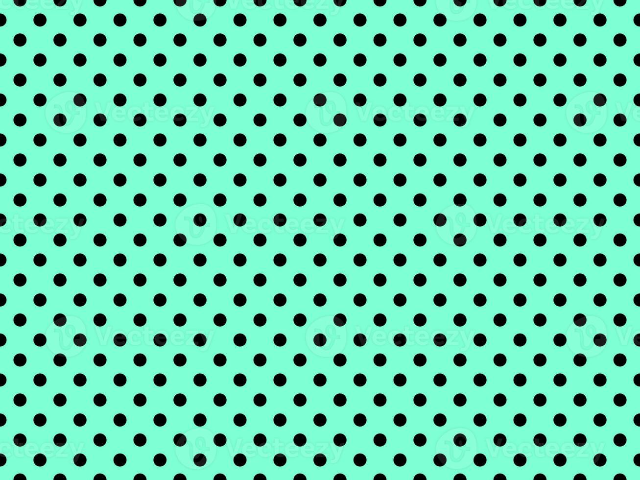 black polka dots over aquamarine background photo