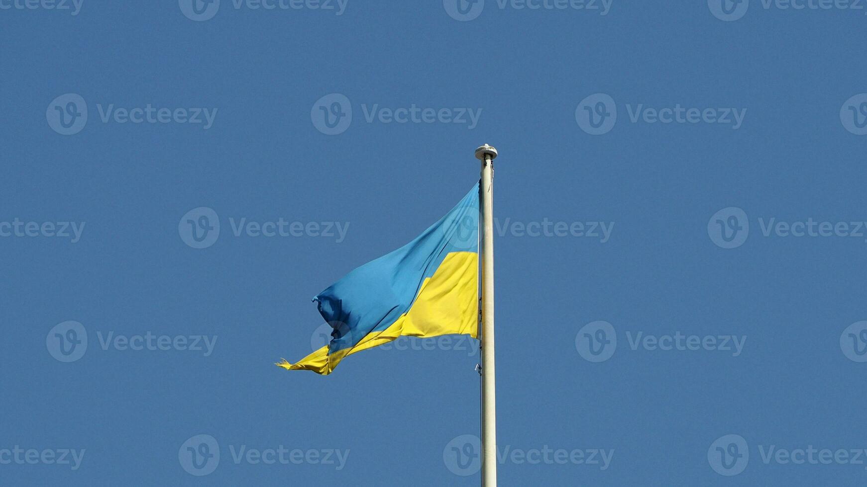 Ukrainian flag of Ukraine over blue sky photo