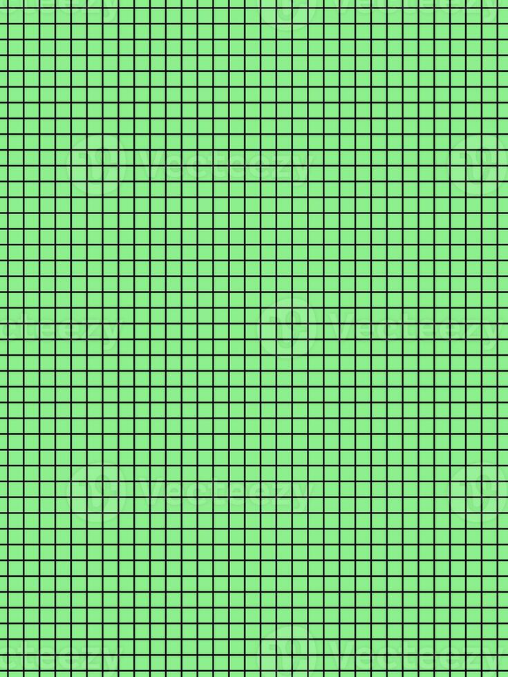 black color graph paper over green background photo