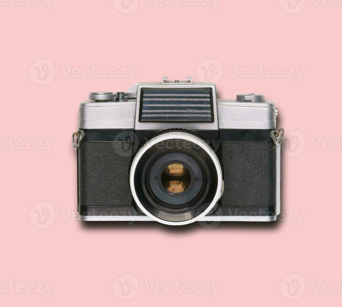 vintage old film camera on pink background photo