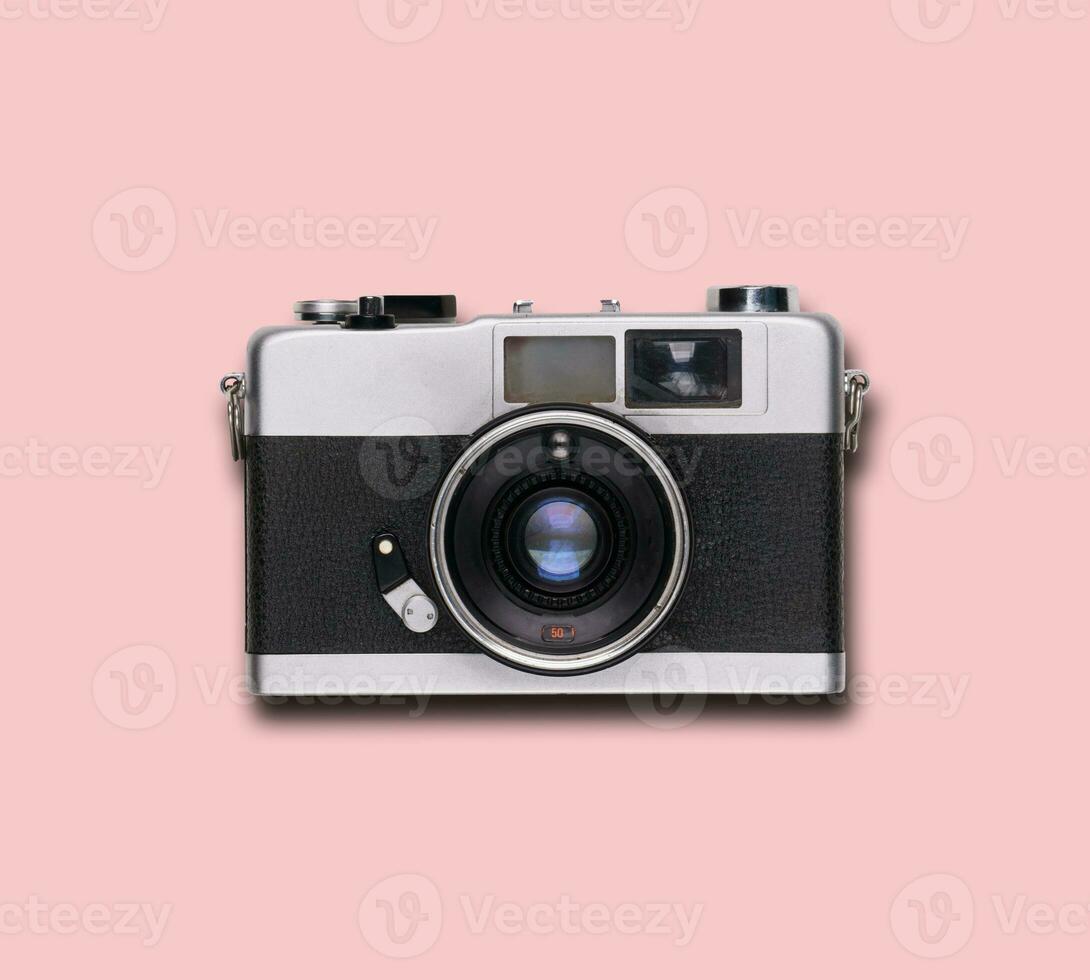 vintage old film camera on pink background photo