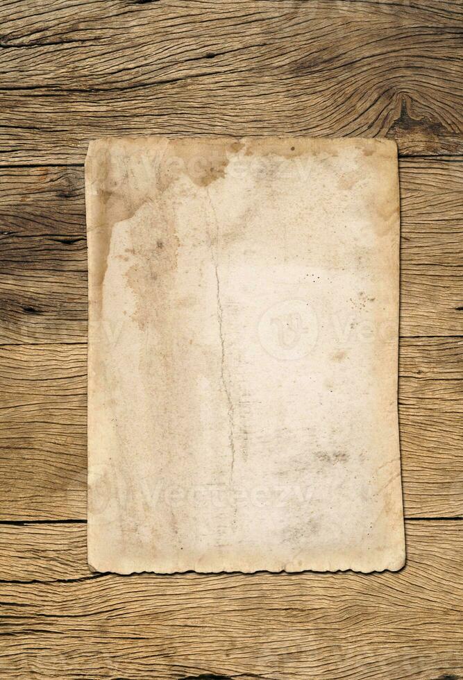 Old paper texture background on wood board photo