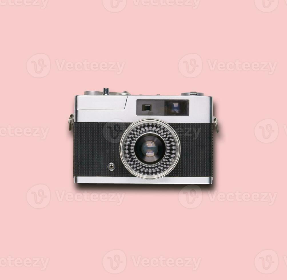 vintage old film camera on pink background photo