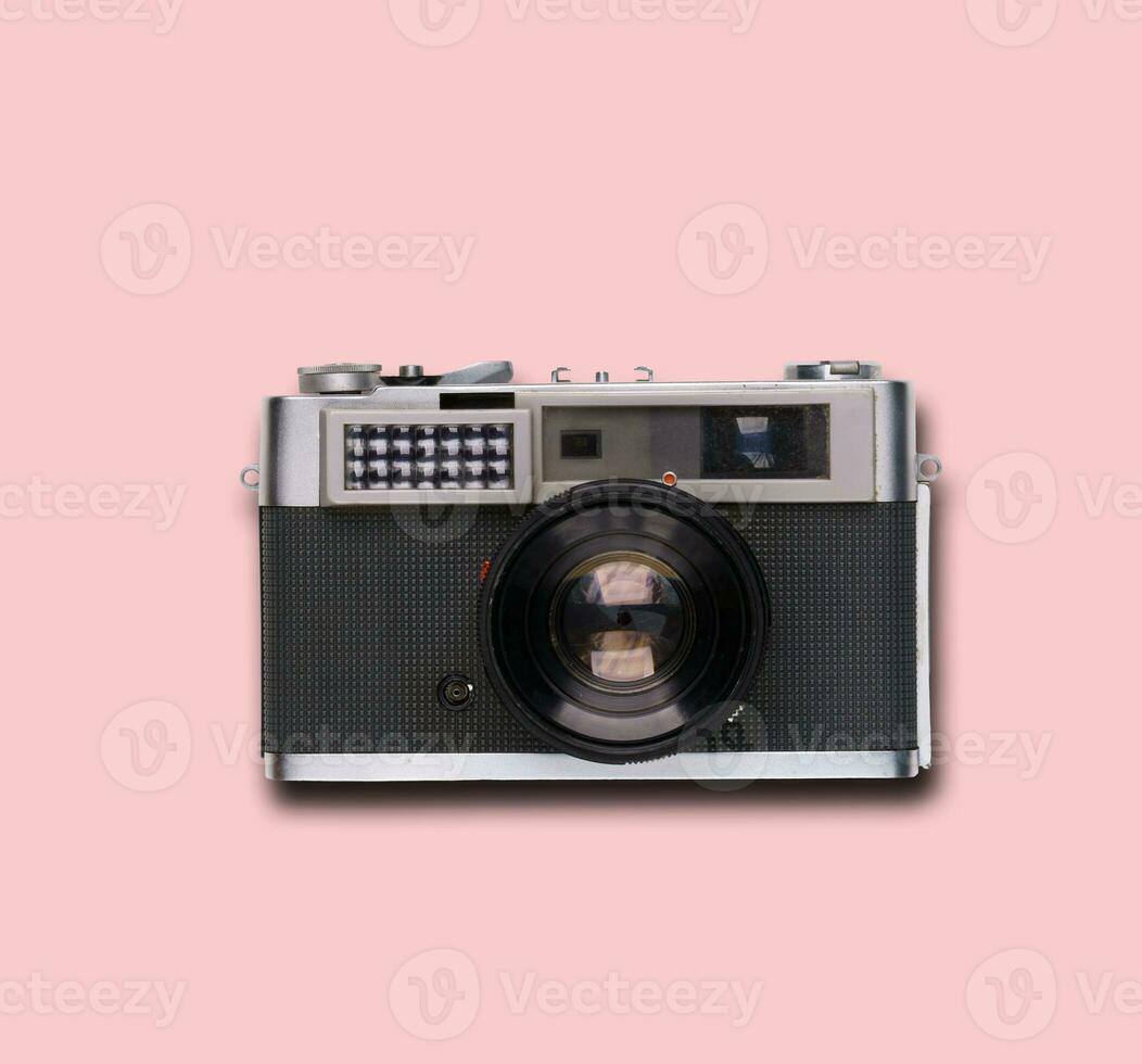 vintage old film camera on pink background photo