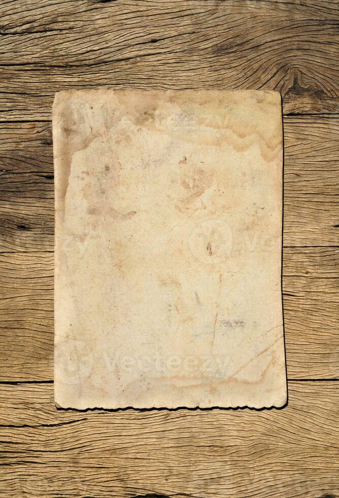 Old paper texture background on wood board photo