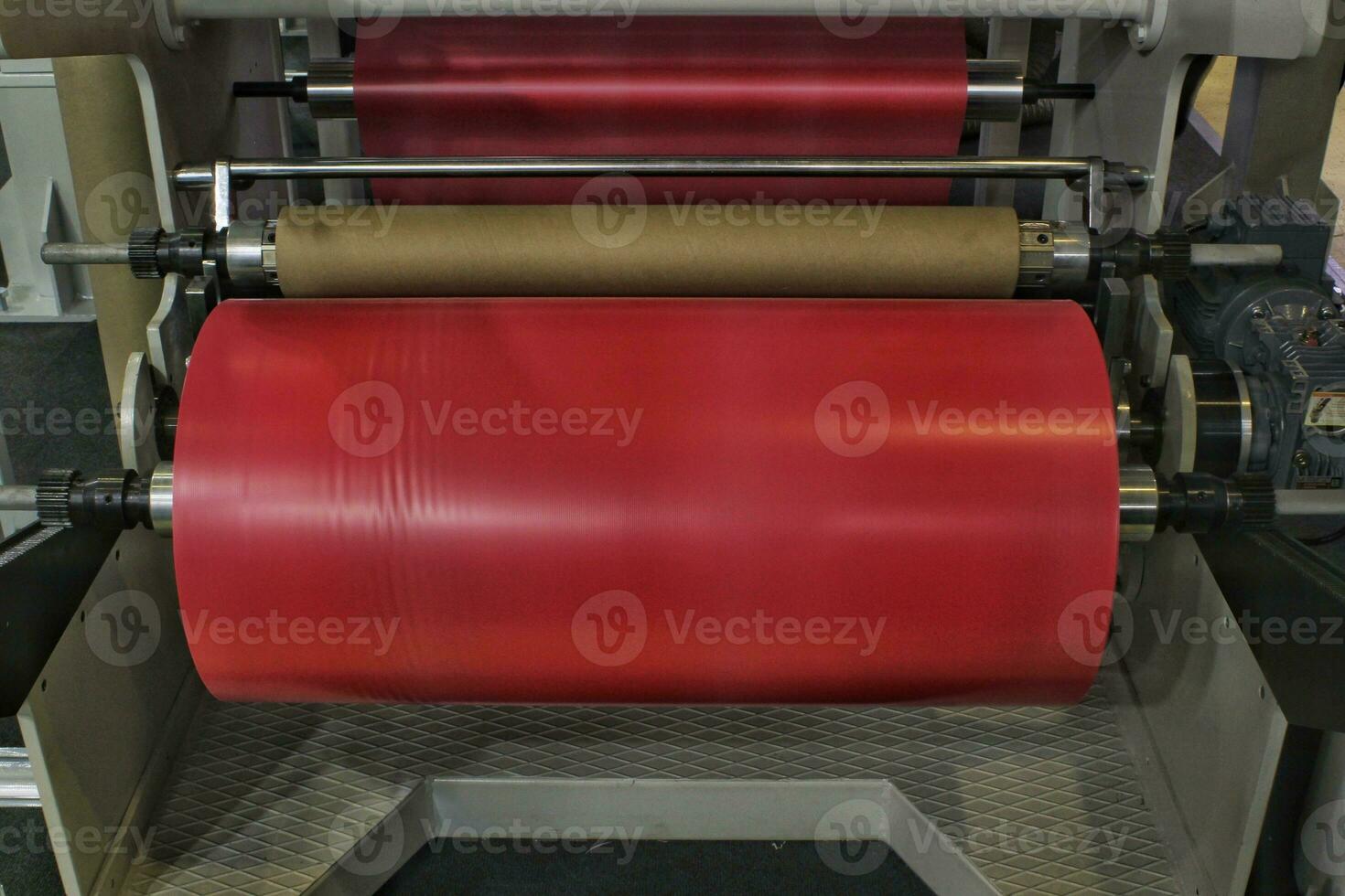 The operation of automatic polyethylene plastic pvc bag production machine. Close-up of roller packaging transparent film. Industrial and technology in factory. Recycling, manufacturing concept photo