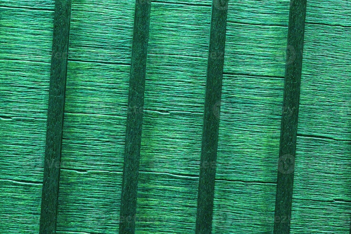 Texture of wooden crossbars. Wall of colored planks. Green fence. Interior slats background. The structure of the boards. Architecture striped panels photo