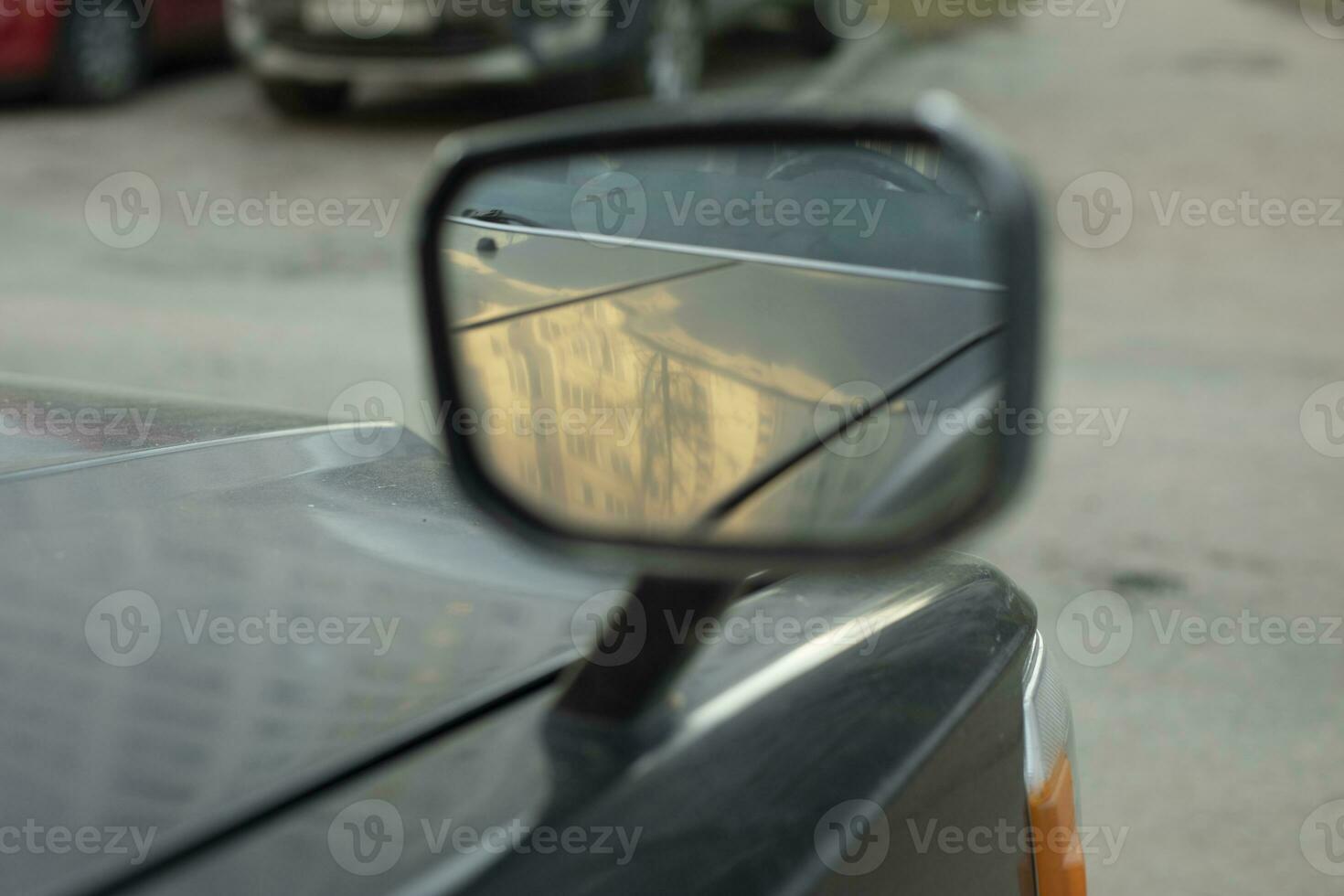 Rear view mirror. Mirror on car is mounted on hood. Overview for driver. photo