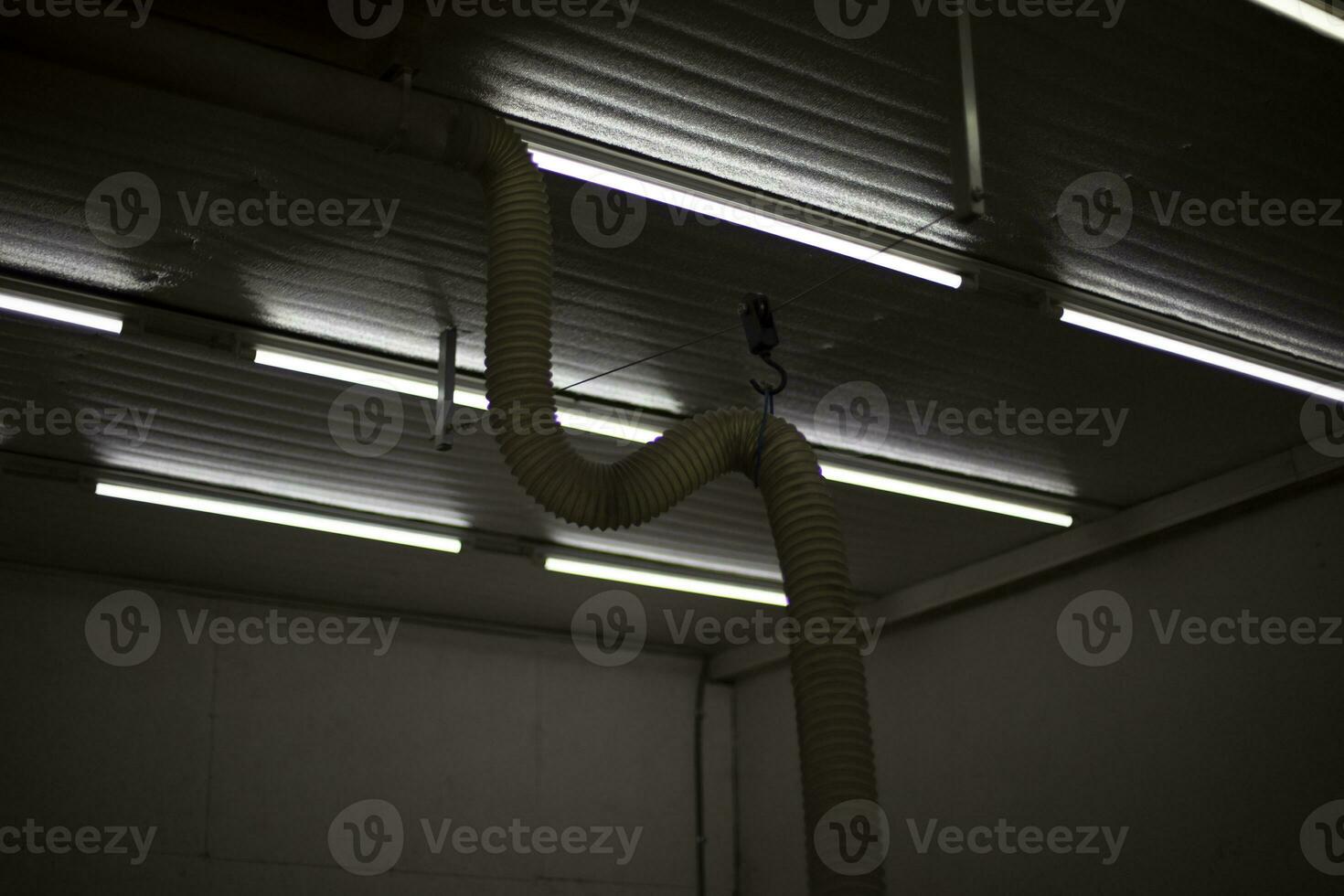 Fluorescent lamps in workshop. Indoor lamps. Light in industrial area. photo