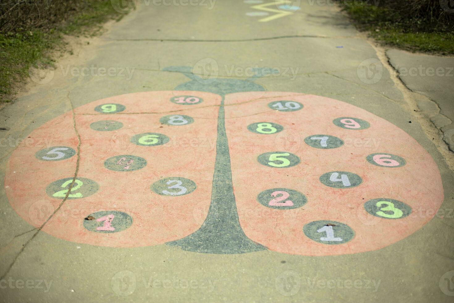 Drawing on asphalt. Ladybug painted on playground. photo