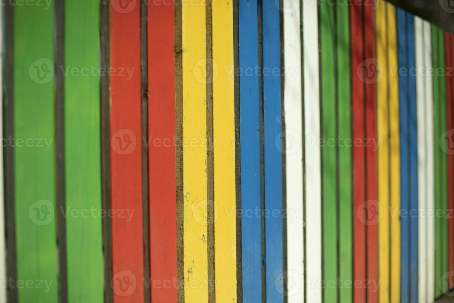 Colored fence. Beautiful fence. Different color on boards. Painted material. photo