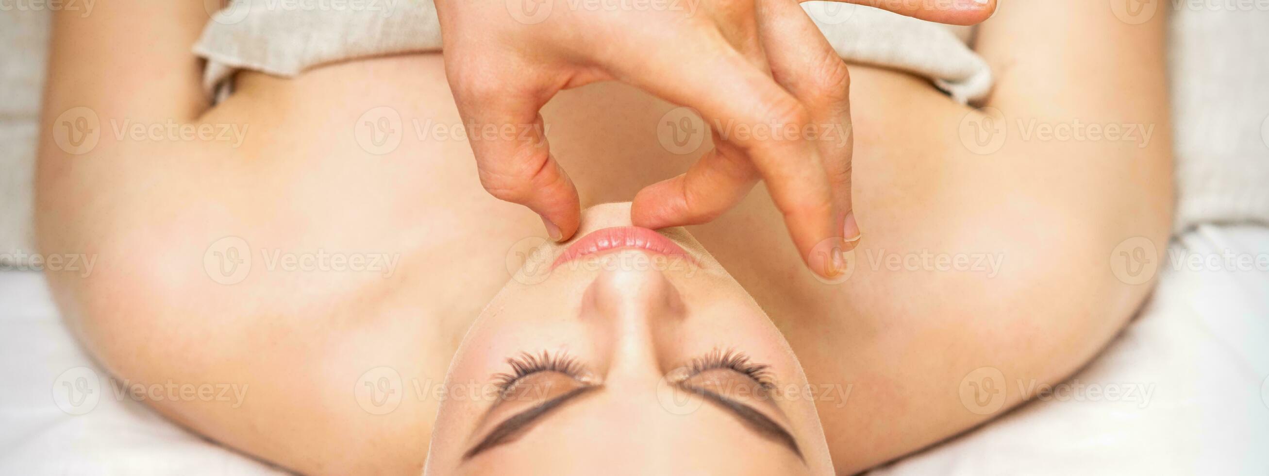 https://static.vecteezy.com/system/resources/previews/026/689/327/non_2x/young-caucasian-woman-receiving-chin-massage-by-male-therapist-fingers-in-spa-salon-photo.jpg