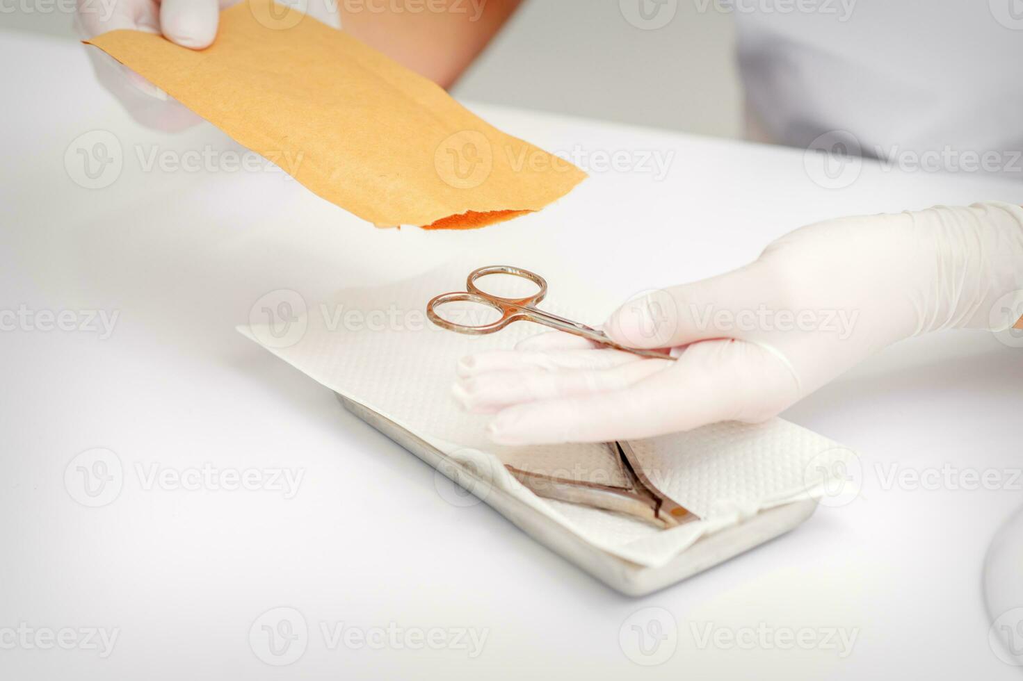 Master of manicure sterilizing manicure scissors. Disinfection of manicure tools. photo