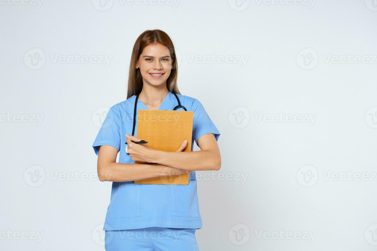 Smiling woman doctor holding clipboard and stethoscope isolated on white background. photo