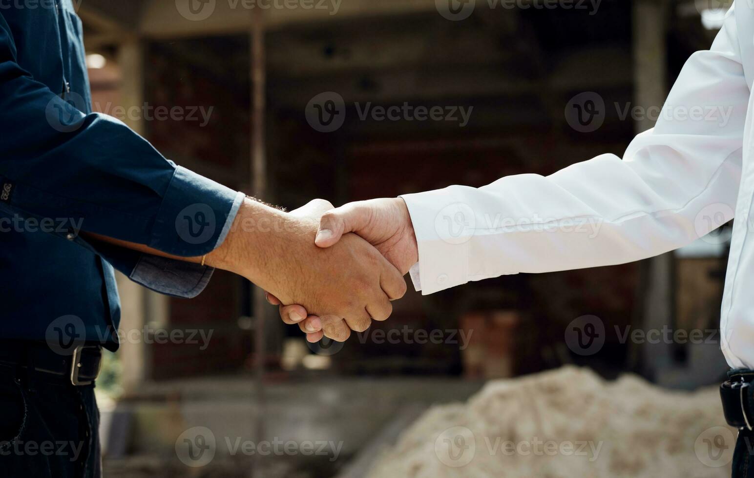 Engineers shaking hands at construction site. photo