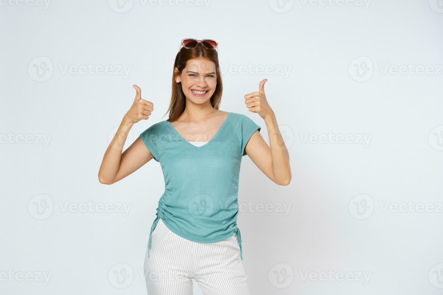 Young woman showing thumbs up isolated on white background. photo