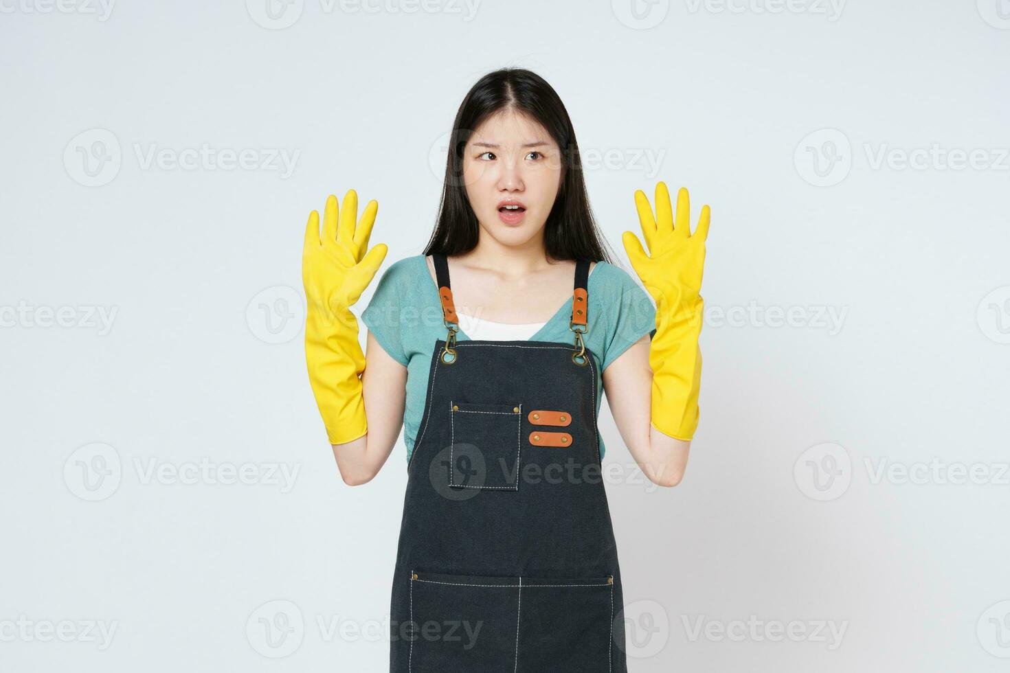 retrato de joven mujer aumento brazos vestir amarillo caucho guantes abierto boca aislado en blanco antecedentes. foto