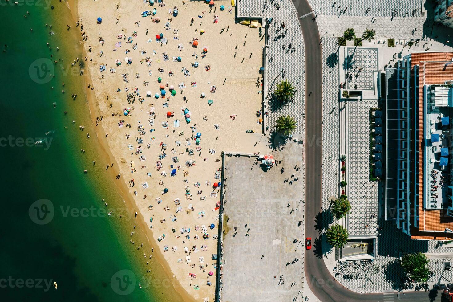 Top down drone view of Ribeira Beach in Cascais, Portugal on a summer day with many people on the beach photo