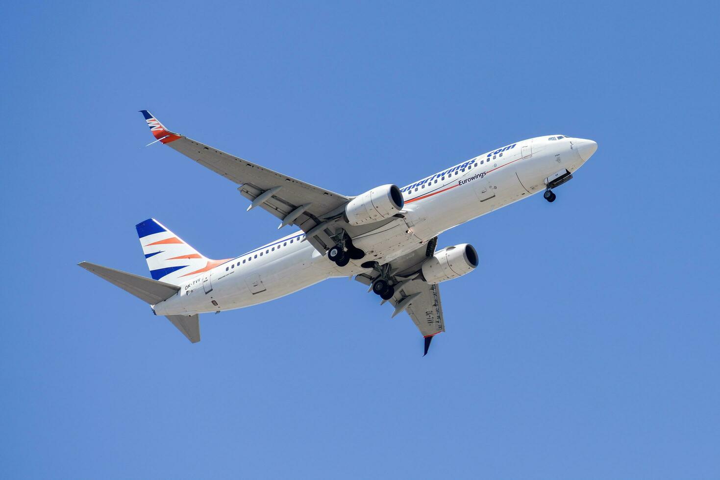 Smartwings air company with aircraft Boeing 737-800 approaching to land at Lisbon International Airport against blue sky photo