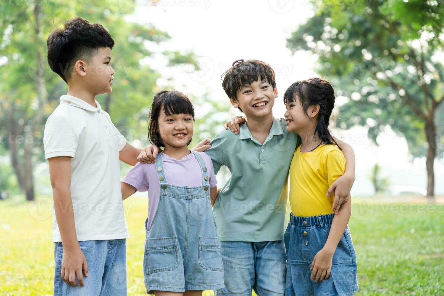 group of cute asian kids having fun in the park photo