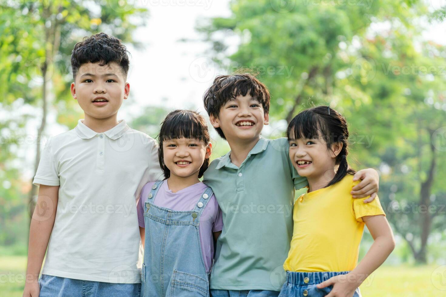 group of cute asian kids having fun in the park photo