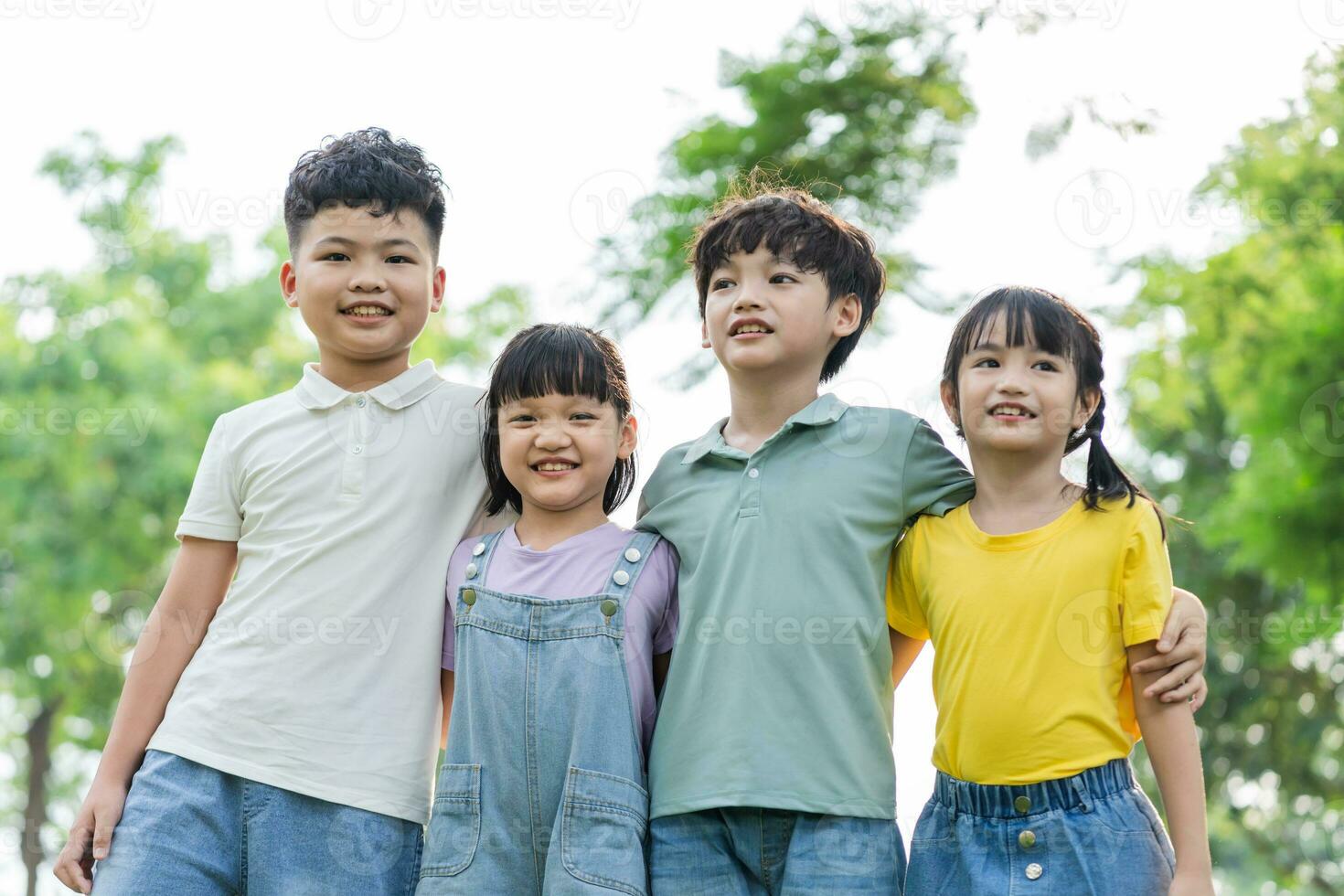 group of cute asian kids having fun in the park photo