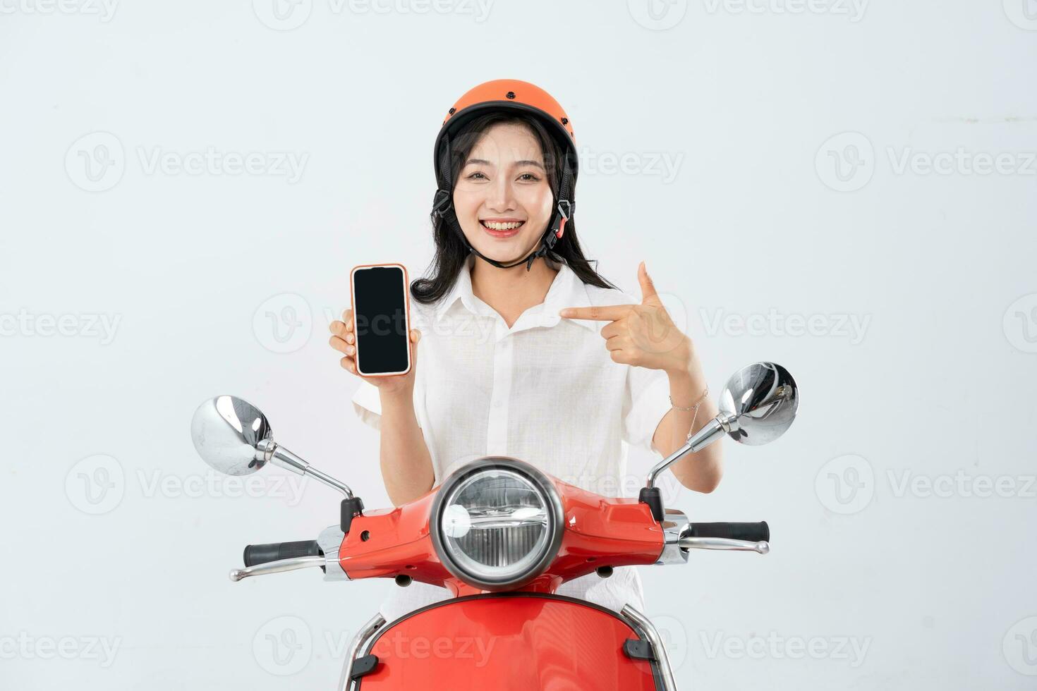 a woman wearing a helmet and driving a motorcycle photo