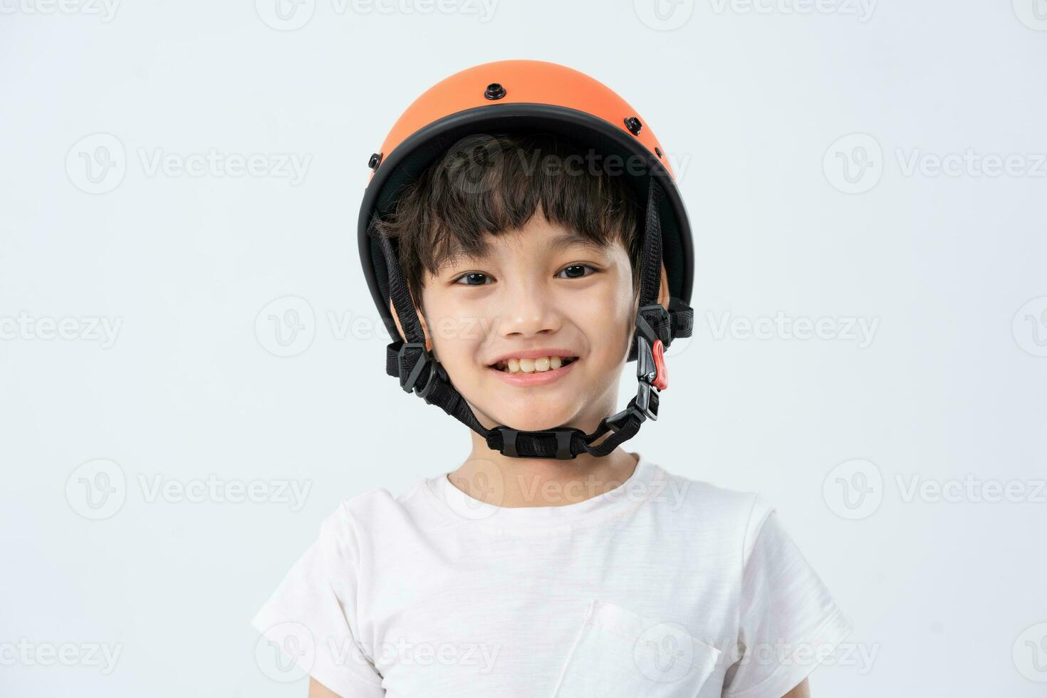 portrait of asian boy wearing orange helmet on white background photo