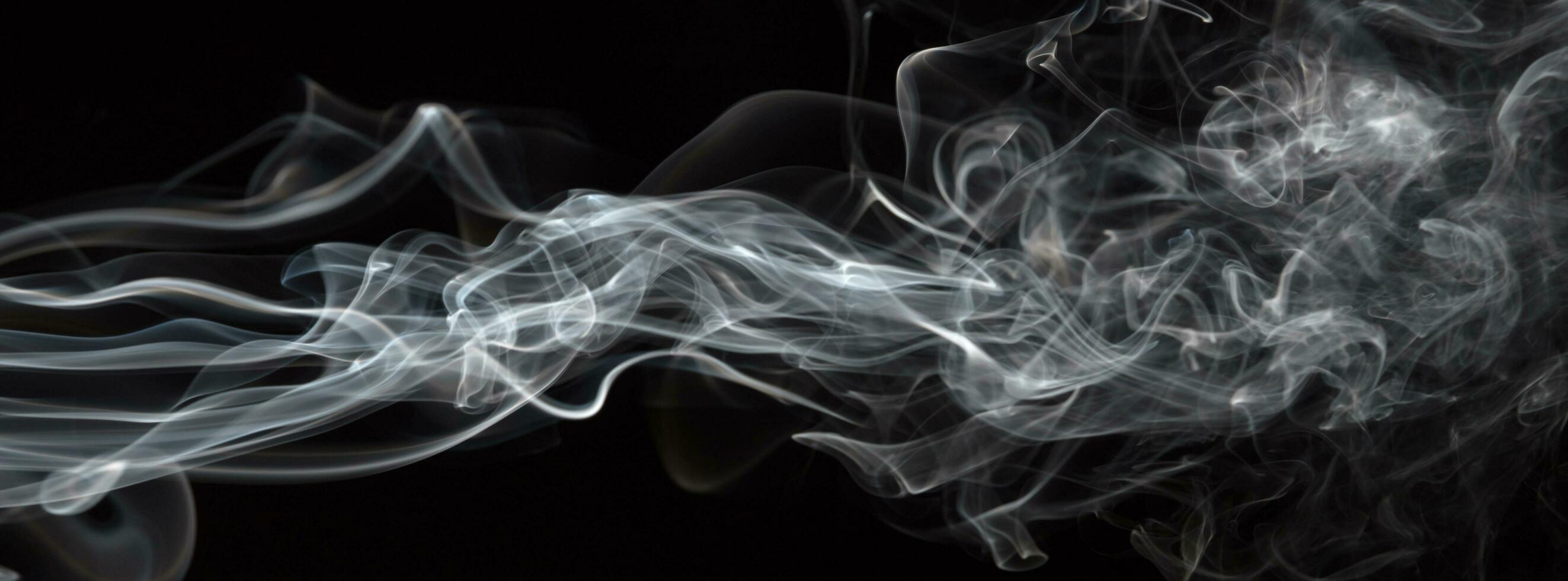 Smoke isolated on black background. Movement of white smoke photo