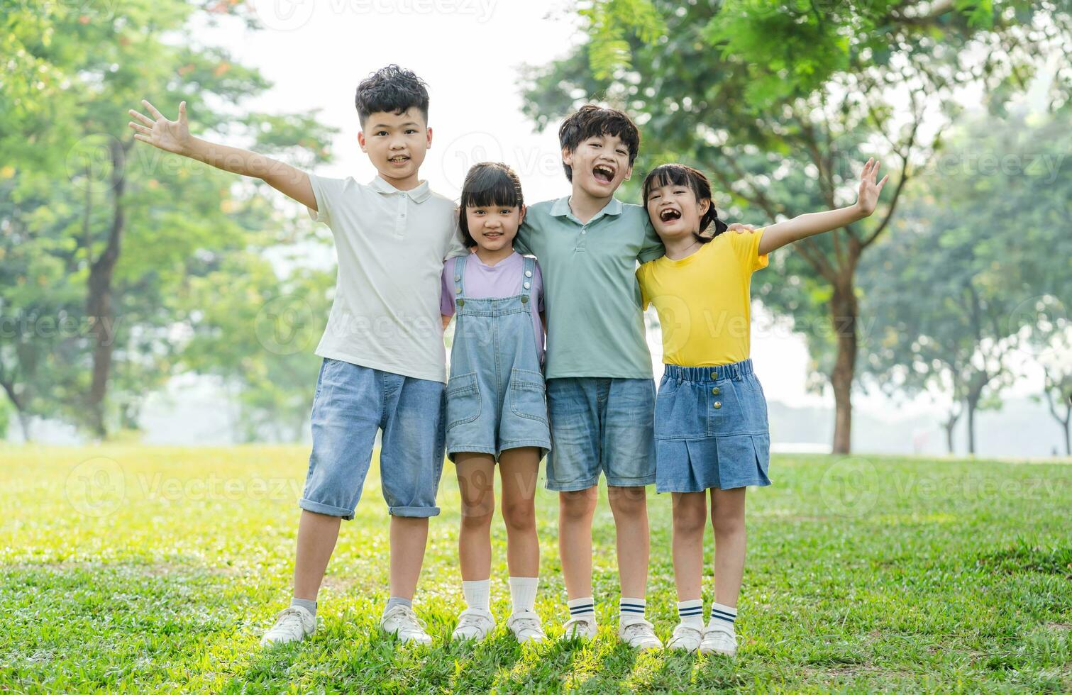 group of cute asian kids having fun in the park photo