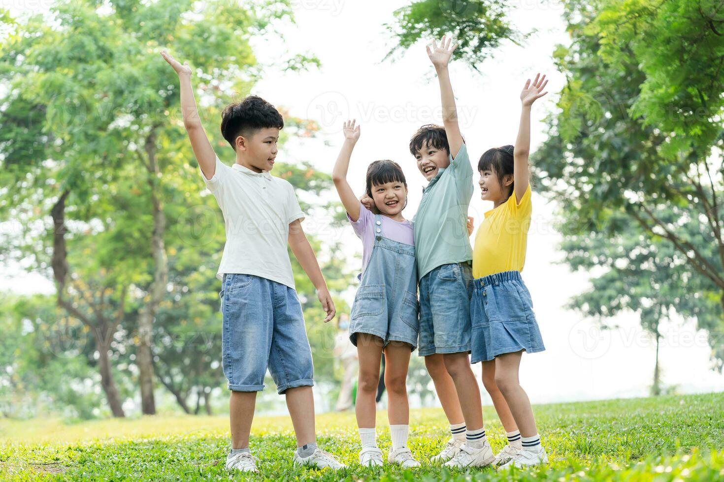 group of cute asian kids having fun in the park photo