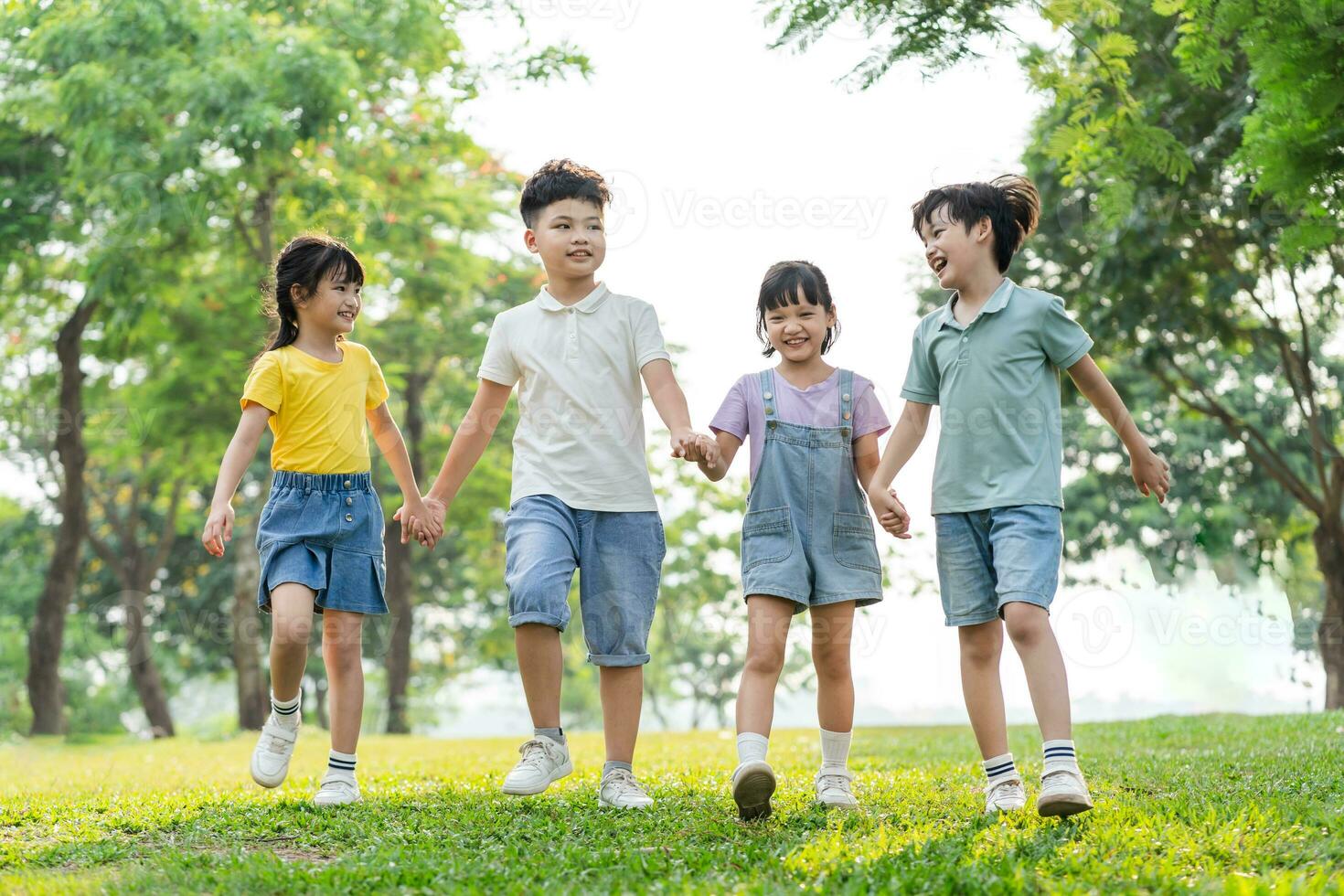 group image of asian children having fun in the park photo