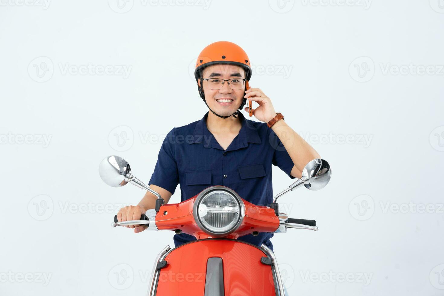 a man wearing a helmet and driving a motorcycle photo