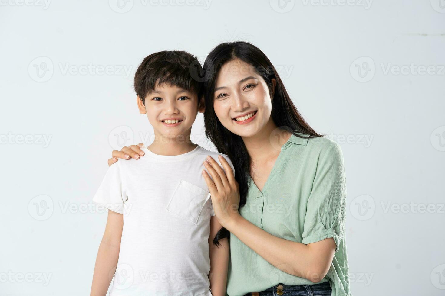 mother and son posing on a white background photo