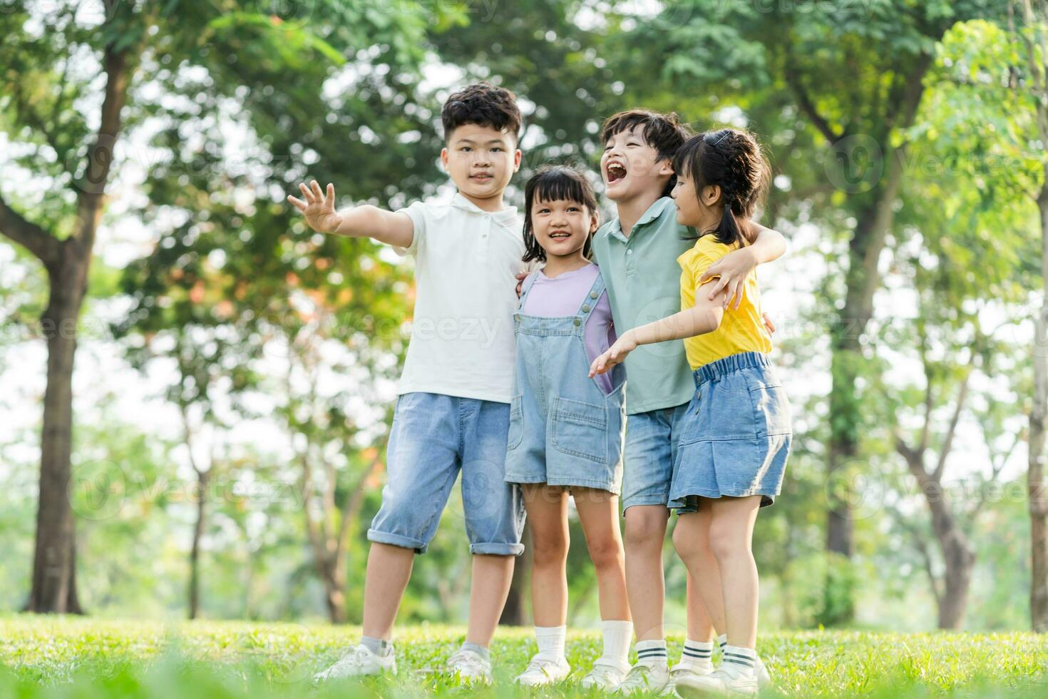 group of cute asian kids having fun in the park photo