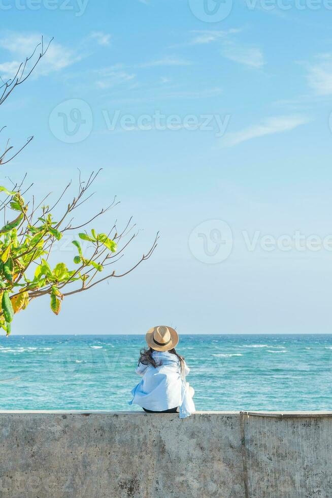 image of a girl and a clear blue beach photo