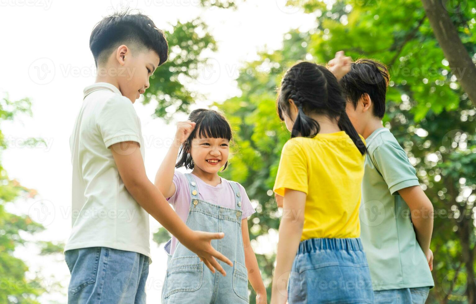 group image of asian children having fun in the park photo