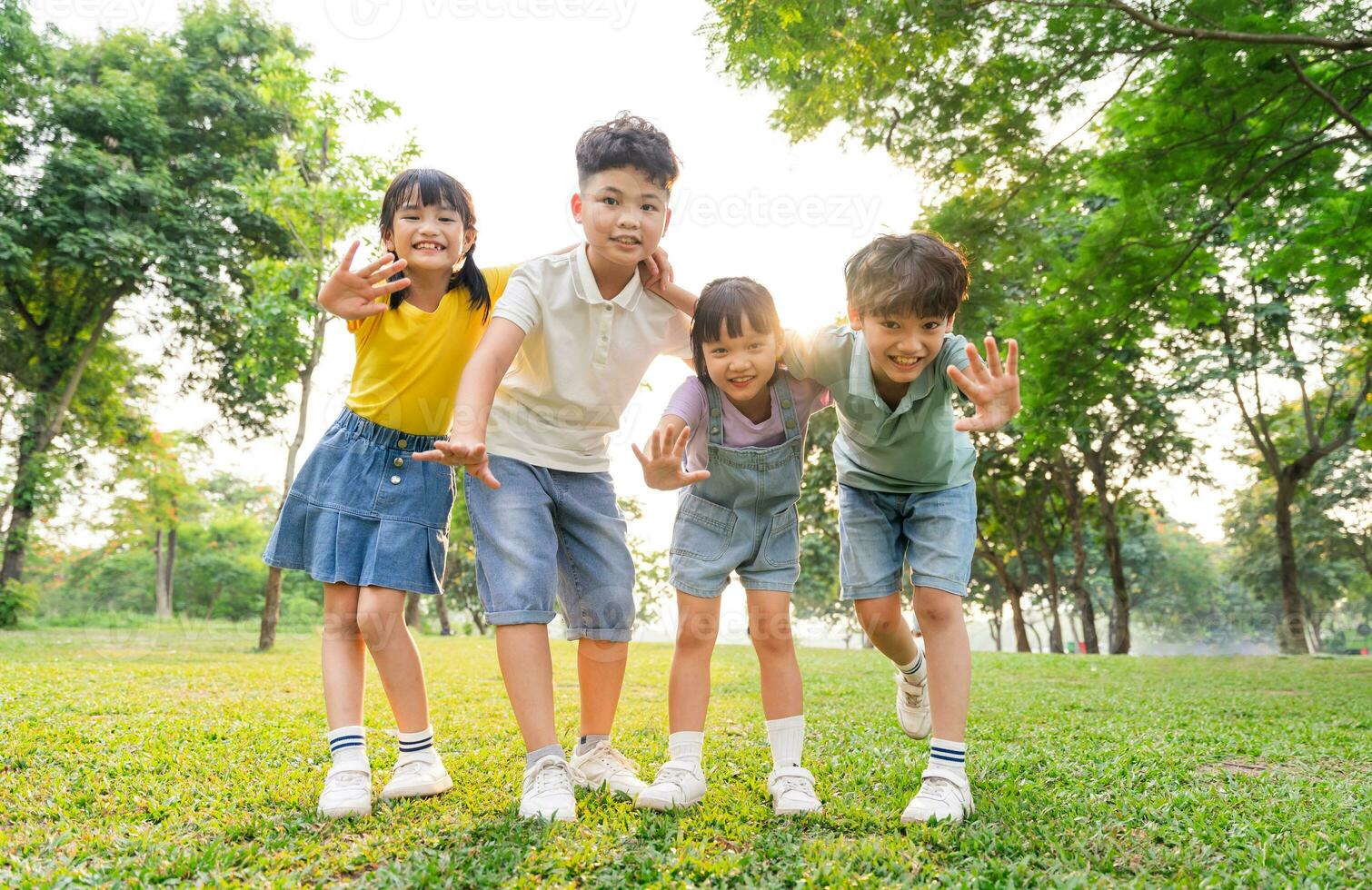 group of cute asian kids having fun in the park photo