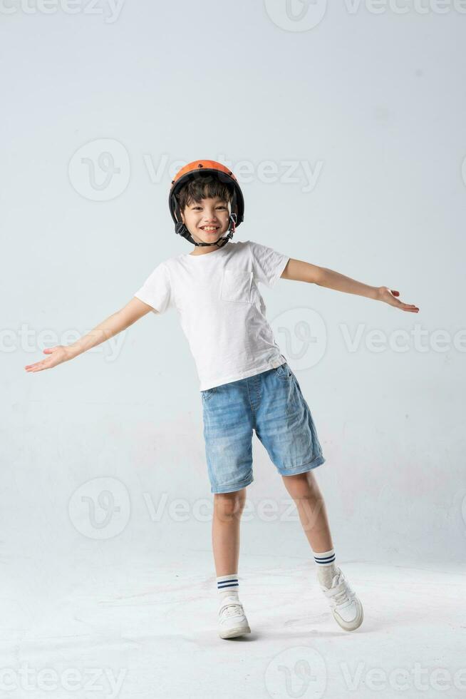 portrait of asian boy wearing orange helmet on white background photo